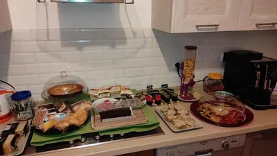a kitchen counter with many different types of food on it at B&B Alle mura di San Giovanni in Rome