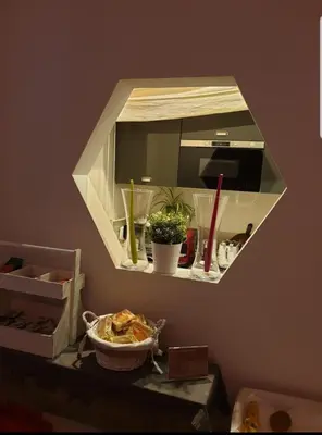 a mirror on a wall above a table with plants at Le Stanze Di Orazio in Rome