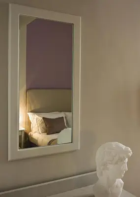 a mirror on a wall next to a white bust at Le Stanze Di Orazio in Rome