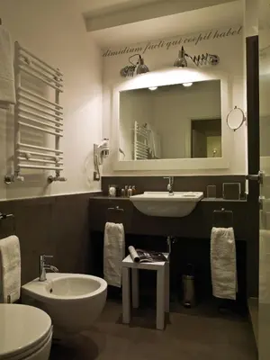 a bathroom with a sink and a toilet and a mirror at Le Stanze Di Orazio in Rome