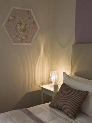 a bedroom with a bed and a table with a lamp at Le Stanze Di Orazio in Rome
