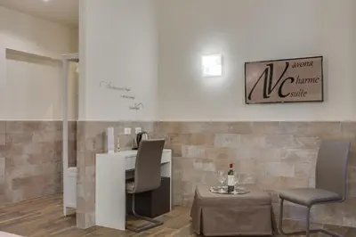 an office with a desk and two chairs and a table at Navona Charme Suite in Rome