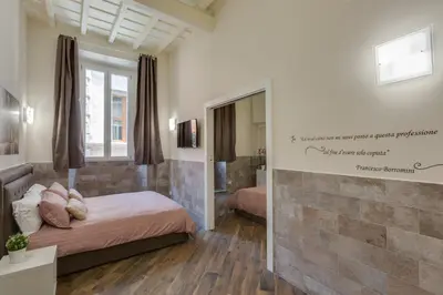 a bedroom with two beds and a mirror at Navona Charme Suite in Rome