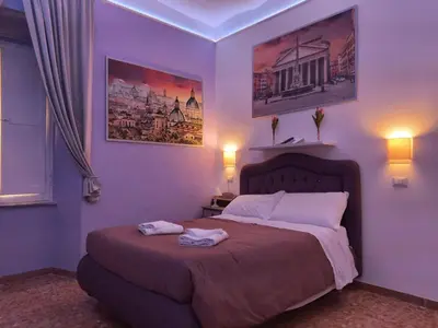 a bedroom with a bed with two towels on it at Royal Vatican in Rome