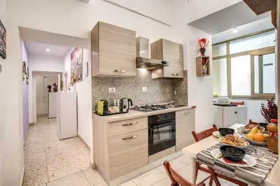 a kitchen with wooden cabinets and a table with food on it at Royal Vatican in Rome