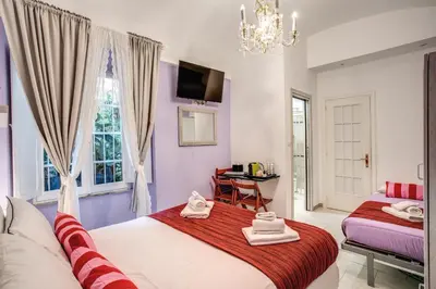 a bedroom with two beds and a window at Royal Vatican in Rome