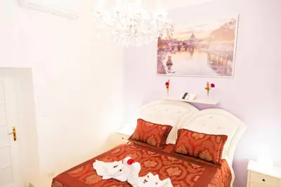a bedroom with a bed with two stuffed animals on it at Royal Vatican in Rome
