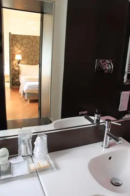 a bathroom with a sink and a large mirror at Sweet Vatican in Rome