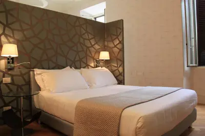 a bedroom with a large bed with a large headboard at Sweet Vatican in Rome