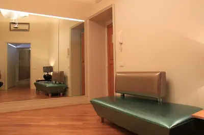 a waiting room with a green chair and a mirror at Sweet Vatican in Rome