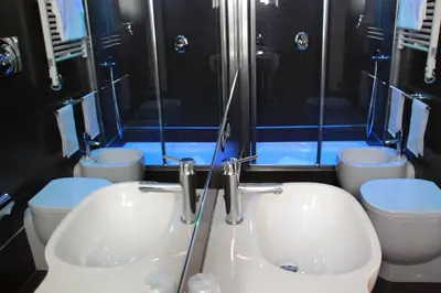 a bathroom with two toilets and a sink and a shower at Sweet Vatican in Rome