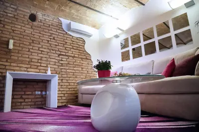 a living room with a couch and a fireplace at Domus Paradiso in Piazza Navona in Rome
