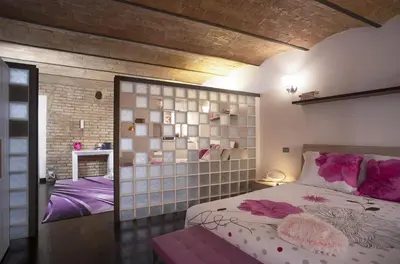 a bedroom with a large bed and a wall with mirrors at Domus Paradiso in Piazza Navona in Rome