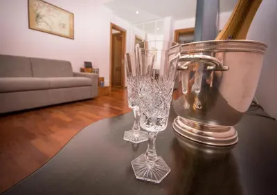 two wine glasses sitting on a table in a living room at Elettra Luxury Home in Rome
