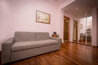 a living room with a couch and wooden floors at Elettra Luxury Home in Rome