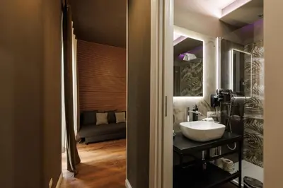 a bathroom with a sink and a mirror at Il Corso Comfort Rooms in Rome