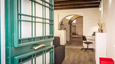 a room with a green door and a living room at Rental in Rome Trastevere White in Rome