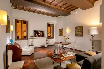 a living room with a couch and a table at Riccardo Condotti Suite in Rome