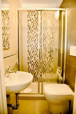 a bathroom with a shower and a sink and a toilet at Albergo Marechiaro in Rome