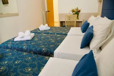 two beds in a hotel room with towels on them at Albergo Marechiaro in Rome