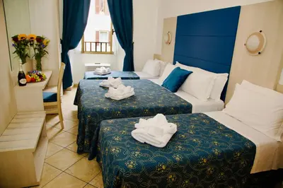 a hotel room with two beds with towels on them at Albergo Marechiaro in Rome