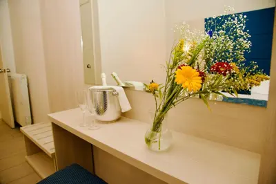 a vase of flowers on a counter in a bathroom at Albergo Marechiaro in Rome