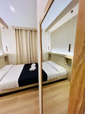 a bedroom with a bed and a mirror at ImeraRooms in Rome