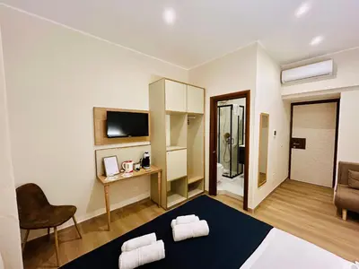 a room with a bed and a desk and a chair at ImeraRooms in Rome