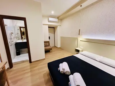 a bedroom with a large bed with towels on it at ImeraRooms in Rome