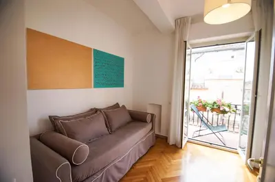 a living room with a couch and a sliding glass door at Rental in Rome Colosseo View Luxury in Rome