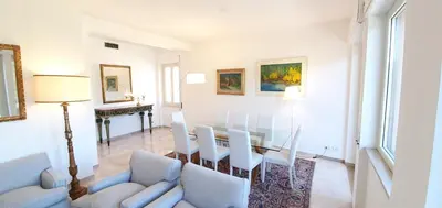 a white living room with a table and chairs at Rental in Rome Colosseo View Luxury in Rome
