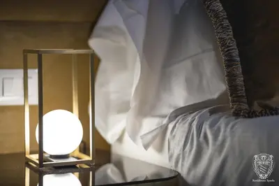 a bedroom with a bed with a lamp next to it at Residenza Spada in Rome