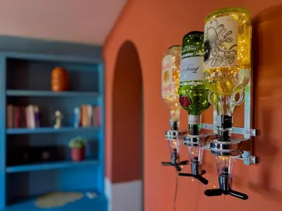 a wine glass holder with three bottles of wine at Dome Terrace Apartment in Rome