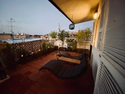a balcony with two benches on a building at Dome Terrace Apartment in Rome