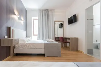 a hotel room with a bed and a bathroom at Luciano Laterani Guest House in Rome