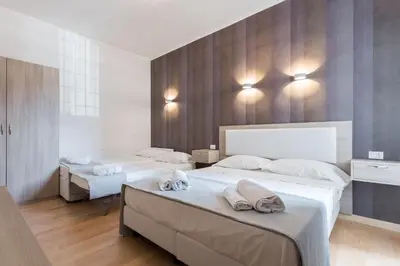 a bedroom with two beds with towels on them at Luciano Laterani Guest House in Rome