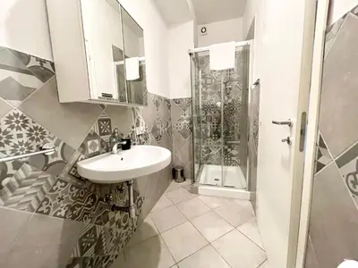 a bathroom with a sink and a shower at Luciano Laterani Guest House in Rome