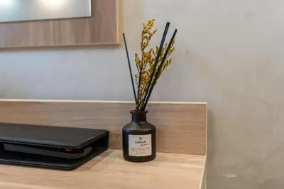 a black vase with sticks in it on a counter at Rome Love Hotel in Rome