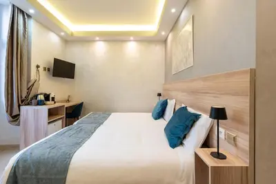 a hotel room with a bed and a desk at Rome Love Hotel in Rome