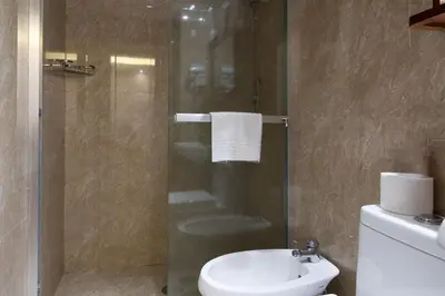 a bathroom with a shower with a toilet and a sink at Rome Love Hotel in Rome