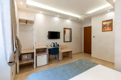 a room with a bed and a desk with a computer at Rome Love Hotel in Rome