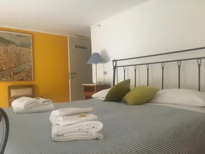 a bedroom with two towels on a bed at Suite Manzoni in Rome