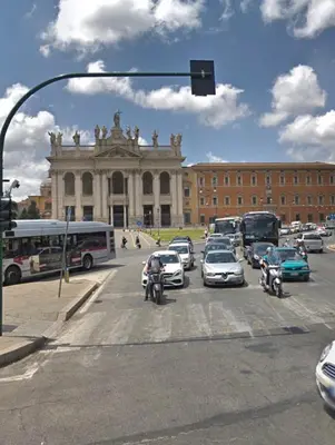 a traffic light in front of a building with cars at Suite Manzoni in Rome