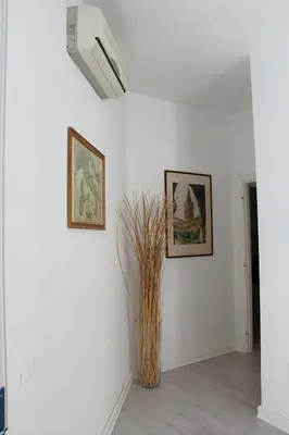 a room with two pictures on the wall and a vase at B&B CultRoma Roof Garden in Rome