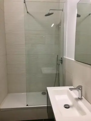 a bathroom with a glass shower and a sink at B&B CultRoma Roof Garden in Rome