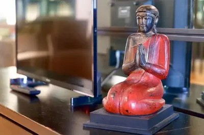 a statue sitting on a desk next to a computer monitor at HT N°9 Colosseo in Rome