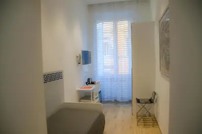 a small room with a bed and a window at Roma Vespahouse in Rome