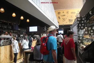 a man with a hat standing in a restaurant at Roma Vespahouse in Rome