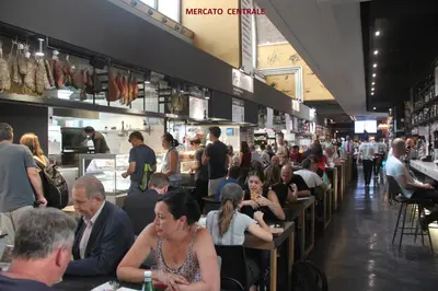 a group of people sitting at tables in a restaurant at Roma Vespahouse in Rome