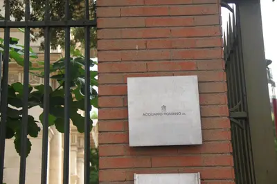 a sign on the side of a brick building at Roma Vespahouse in Rome